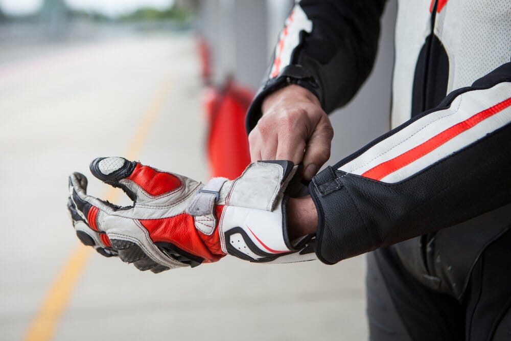 Person putting on racing gloves